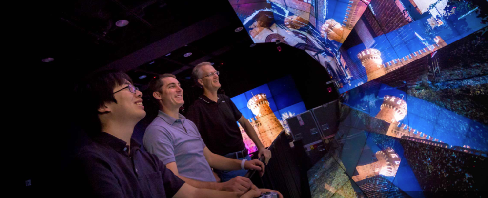 From left, Eric Lo, structural engineering Ph.D. student Michael Hess and Falko Kuester in the WAVE lab navigating the Turin virtual reality. Photo by Erik Jepsen/UC San Diego Publications
