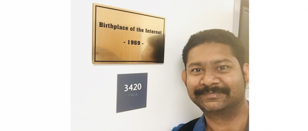 Pranay Bhattacharyya stands next to the "Birthplace of the Internet" plaque in Boelter Hall