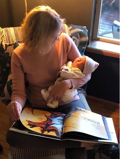 Jenn Stringer, UCB CIO, reads to her newest grandchild.
