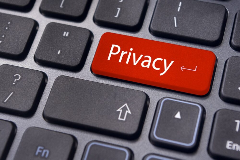 Computer keyboard with the word "privacy" highlighted in red