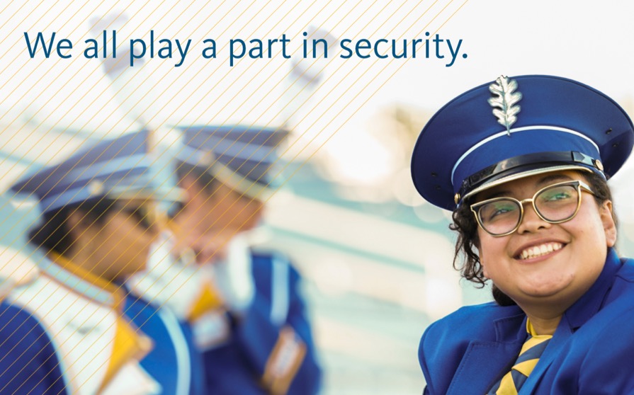 We all play a part in security - photo of woman in hat smiling with two others in background