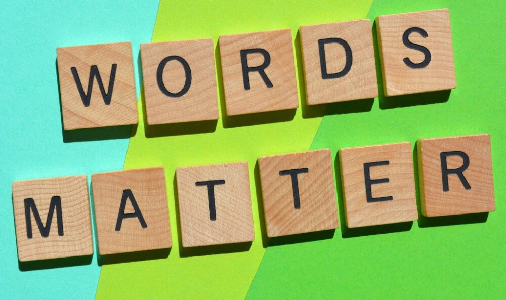 "Words matter" written with Scrabble blocks